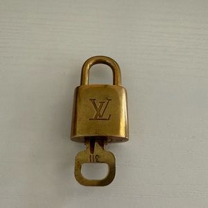 #311 Louis Vuitton authentic padlock and key.